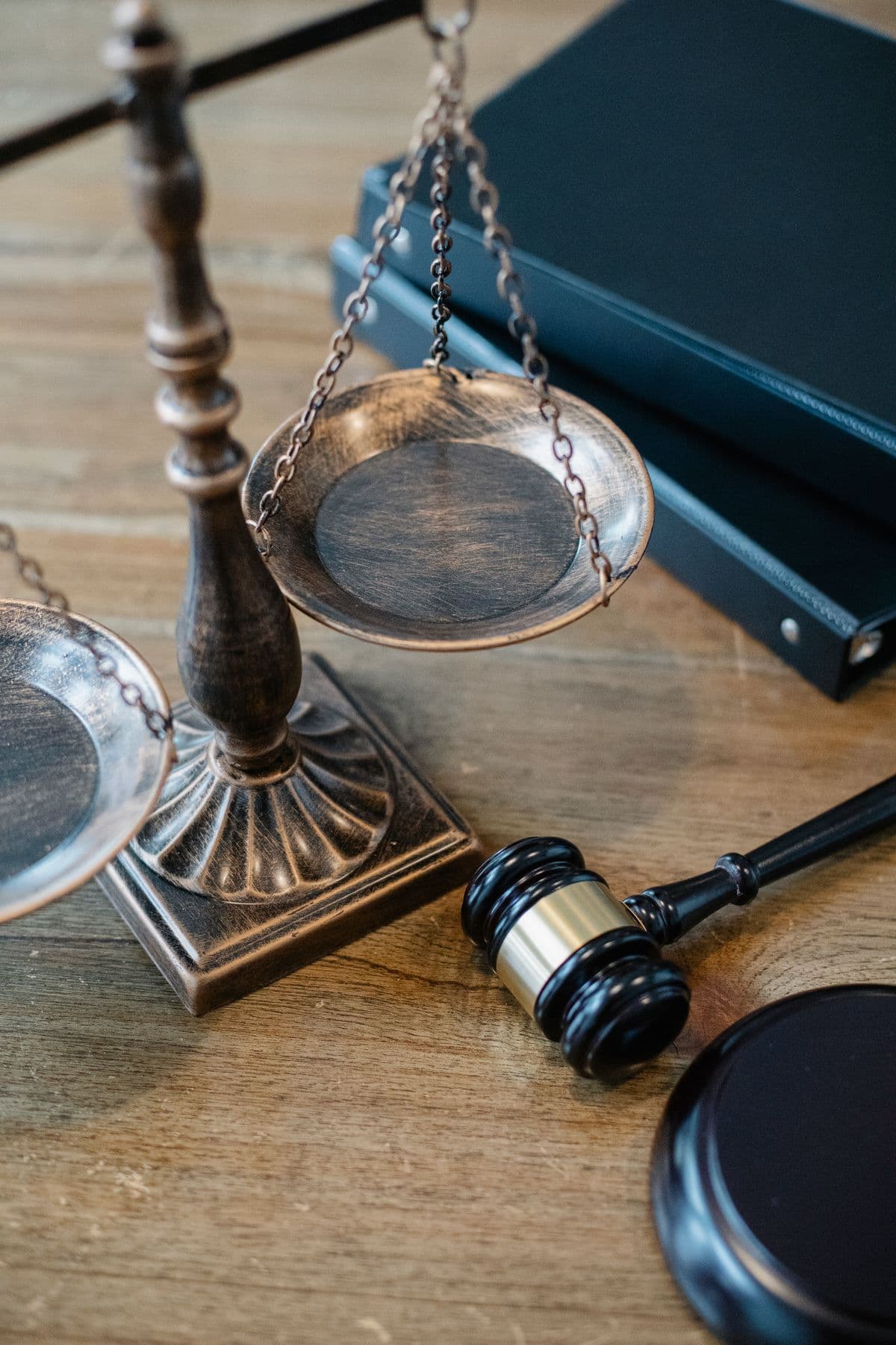 A brass balance scale resting beside a gavel